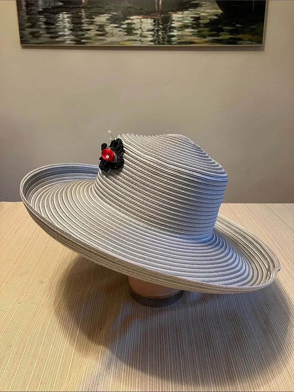 Wide Brim Straw Hat with Black Decorative Knot and Red Floral Accent